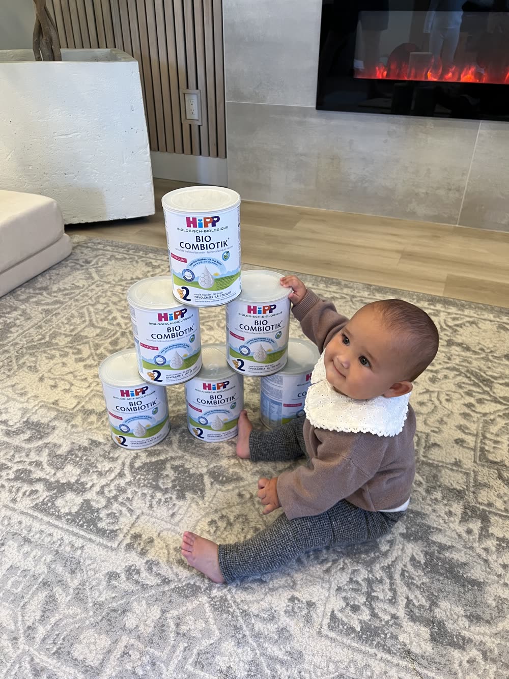 Kseniia's baby hugging a can of HiPP Dutch